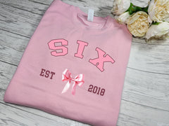 Personalised Kids / adults unisex BABY PINK welsh bow BIRTHDAY AGE year jumper